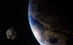 地球に接近する小惑星のイメージ。